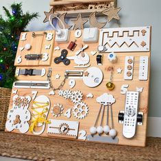 a wooden board with various items on it and a christmas tree in the back ground