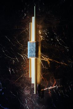 an artistic image of a blue and yellow clock on a wall with marbled surface