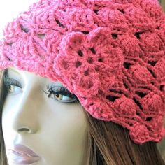 a mannequin wearing a pink crocheted hat