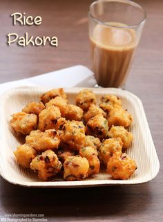 rice pakora is served on a plate with a glass of coffee