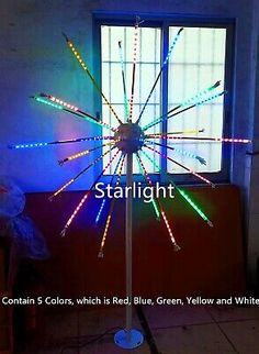 a colorful light up windmill in front of a window with the words starlight on it