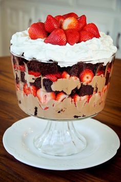 a cake with strawberries on top is sitting on a plate