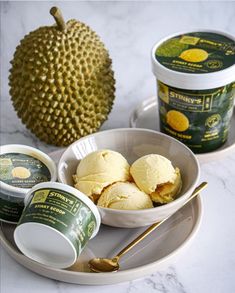 an assortment of ice creams on a plate with a dragon fruit in the background