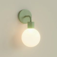 a light that is on the wall next to a white wall with a green handle