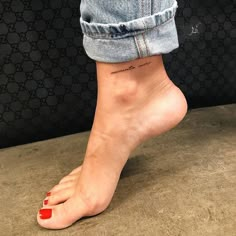 a woman's foot with a small tattoo on the side of her left leg