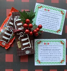 two candy bars with christmas decorations on top of them next to an envelope that says merry