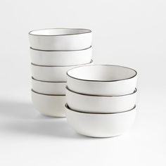 five white bowls stacked on top of each other in front of a white background with black lines