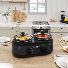 two plates with food on them sit in front of an electric cooker and oven