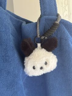 a stuffed animal is hanging from a blue bag