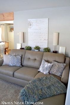 a living room filled with furniture and pillows