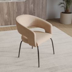 a beige chair sitting on top of a white rug