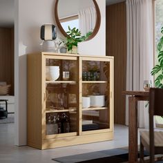 a wooden cabinet with glass doors and plates on it