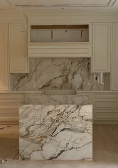 a kitchen with marble counter tops and cabinets in the process of remodeling