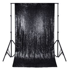 a black and white photo backdrop on a tripod with the light up behind it