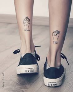 a woman's legs with tattoos on them