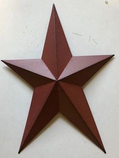 an origami star on a white table