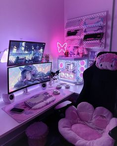 a computer desk with two monitors and a keyboard on it, in front of a pink wall