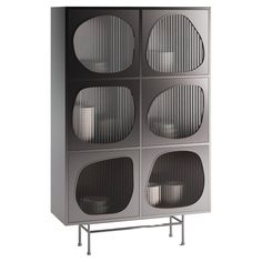 a tall gray cabinet with four round glass doors