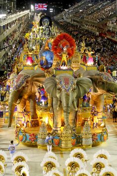 an elephant float is in the middle of a parade