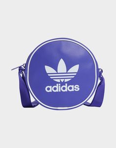 Whether you're hitting the streets or heading to a festival, this adidas bag has you covered. Carry all your essentials in the main zip compartment. Adjust the strap to your perfect length and you're ready to get going. Made from durable yet lightweight polyurethane, this retro-inspired bag is an everyday essential built to last.• Dimensions: 5 cm x 17 cm x 17 cm• Volume: 1.5 L• 100% polyurethane• Zip main compartment• Adjustable strap Adidas Bag, Purple Adidas, Adidas Bags, Round Bag, Jd Sports, Volume 1, Sport Fashion, Retro Inspired, The Streets