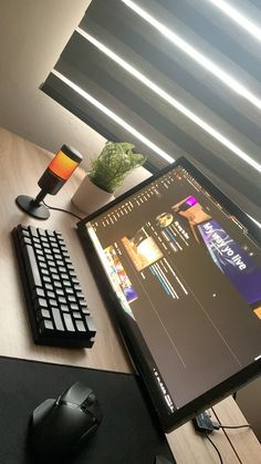 a computer monitor sitting on top of a wooden desk next to a keyboard and mouse