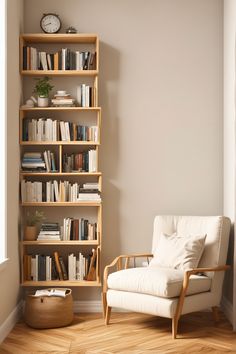 a white chair sitting in front of a book shelf filled with books