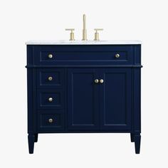 a blue vanity with two sinks and gold faucets