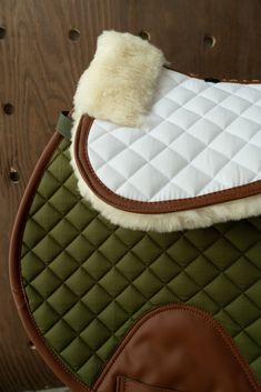 a close up of a horse saddle with sheepskins on it's back