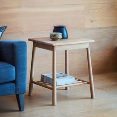 a blue chair and table in front of a wooden wall