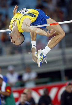 a man is in the air doing a high jump