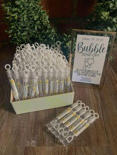 a box filled with lots of white toothbrushes on top of a wooden table