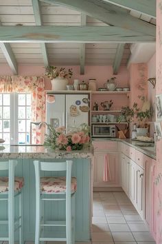 a kitchen with pink walls and floral curtains on the windowsills is pictured in this image