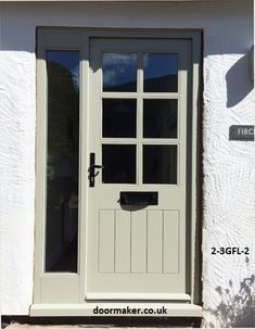 a white door with glass on the side of a house