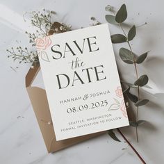 save the date card on top of an envelope with flowers