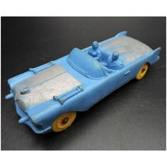 a blue toy car sitting on top of a table