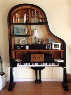 a piano sitting in front of a bookshelf