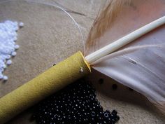 a feather and some beads on a table