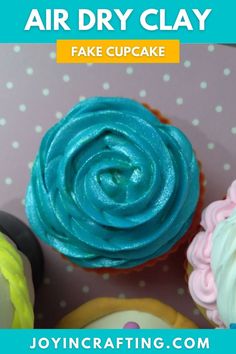 three cupcakes with blue icing and pink frosting on them, one is in the shape of a flower