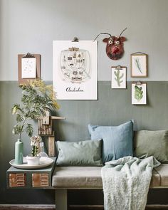 a living room filled with lots of furniture and pictures on the wall above it's couch