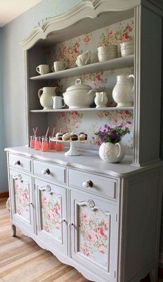 an old china cabinet with flowers on it