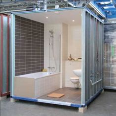 a bathroom with a toilet, tub and shower stall in the middle of a room