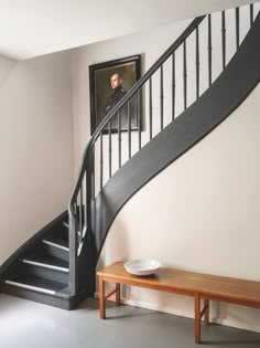 there is a bowl on the table next to the stairs