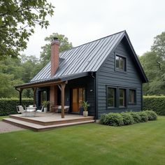 a black house with a metal roof and steps leading up to the front porch area