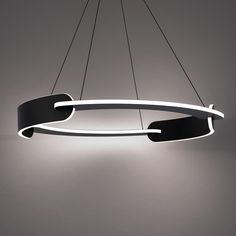 a black and white circular light hanging from the ceiling