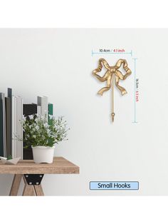 a clock that is on the wall next to a desk with books and plants in it