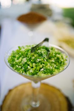 there is a small glass with some green food in it