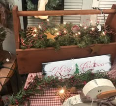 an outdoor christmas display with pine cones, evergreens and other holiday decorations on the table