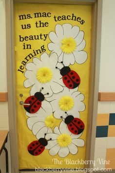 a classroom door decorated with daisies and ladybugs for the teacher's day