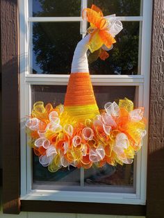 an orange and yellow wreath on a window sill with the words wheats by gramm