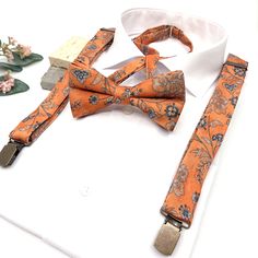 Burnt Orange Floral Suspenders, Burnt Orange Bow tie, Suspender Bowtie, Wedding Floral Suspenders, Groomsmen Suspenders, Ring bearer outfit Welcome to Justformanboutique! It is a wonderful set that I have prepared completely handmade from first quality fabric and you will not find it in any other store. Please message me if you would like more information about this suspenders and bow tie set that will make you feel unique on your most special days.  If you want to buy the tie of the same produc Orange Ring Bearer Outfit, Burnt Orange Bow Tie, Floral Suspenders, Suspenders Ring Bearer, Black People Weddings, Suspenders Groomsmen, Periwinkle Wedding, Orange Bow Tie, Bowtie Wedding